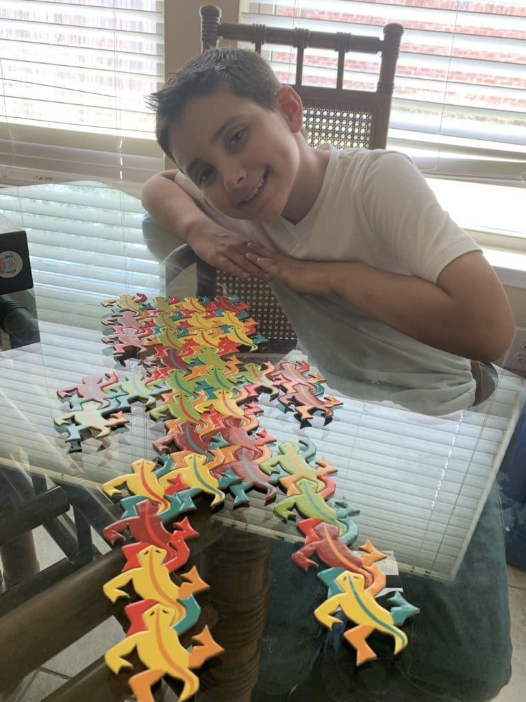 Student with completed tessellating design using perpetual puzzle